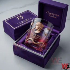 A Taylor Swift eras memorial whiskey glass in a purple gift box with the number thirteen and elegant gold lettering!