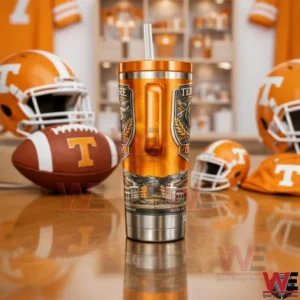 Tennessee Volunteers 135 Years Collector’s Edition Tumbler 5 Back view of a Tennessee Volunteers 135 years tumbler with handle and straw standing on a table with football helmets and team themed decor behind it!