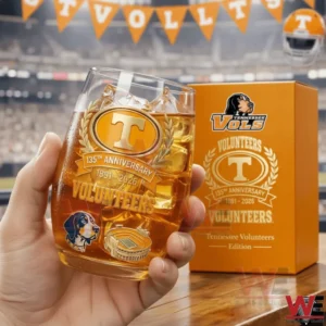 Hand holding a Tennessee Volunteers anniversary whiskey glass with ice and team branding in a stadium background!