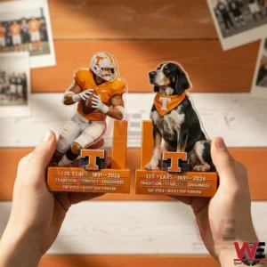 Hands holding Tennessee Volunteers anniversary bookends showing an orange uniform football player and a hound dog mascot with anniversary text.