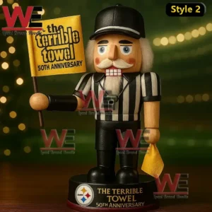 Wooden referee figure holding a Terrible Towel fiftieth anniversary flag and towel on a base with Steelers branding and warm lights behind.