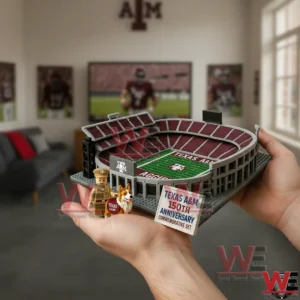 Texas A&M Aggies Aggie Stadium 150th Anniversary Building Blocks Set 4 Hands holding a Texas A and M building block stadium model with a cadet figure and dog mascot figure beside a 150th anniversary commemorative sign in a fan themed room!