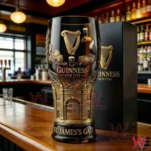 A collectible Guinness beer glass with heritage design elements standing prominently on a bar surface with warm pub lighting in the background!