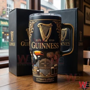 Black and gold Guinness commemorative tumbler with ornate design placed on a wooden table inside an Irish style pub!