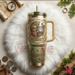 The Hobbit Gandalf and Bilbo 40oz Tumbler 5 The Hobbit themed tumbler with Bilbo and Gandalf artwork handle lid and straw displayed on a white fur background with fantasy props!