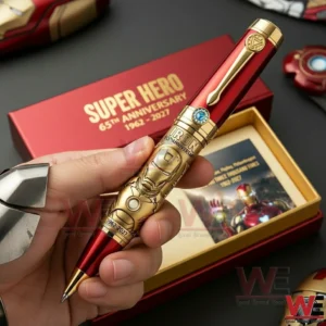 A Close Up Of An Iron Hero Themed Pen In A Person Hand Featuring A Gold Helmet Design And Luxury Detailing!