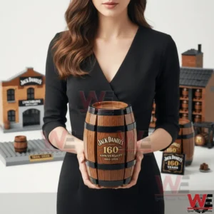 The Jack Daniel’s 160th Anniversary Heritage Brick Edition 4 This image features a model holding the Jack Daniels 160th anniversary barrel themed piece in a clean studio setting! The presentation helps viewers understand scale shape and visual presence! It emphasizes the premium look inspired by classic whiskey barrels!