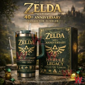 Dark green Zelda anniversary handled tumbler with straw displayed next to a matching collector box in a fantasy landscape with a sword and ruins!