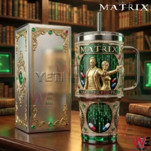Matrix inspired insulated tumbler with gold detailing green digital code artwork and take the red pill text standing on a wooden table next to a premium box!