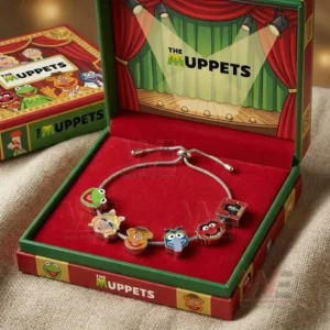 Gift boxed adjustable charm bracelet with The Muppets themed character face charms inside a red velvet presentation box with stage artwork.