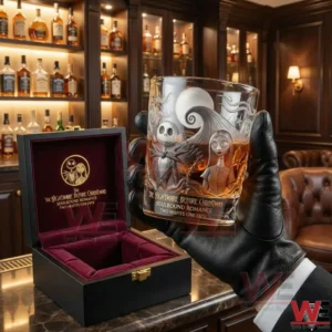 A Dark Romance themed collector whiskey glass held in a gloved hand with intricate gothic artwork and a refined bar display behind it!