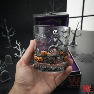 Hand holding a The Nightmare Before Christmas whiskey glass featuring Jack Skellington and Halloween artwork!