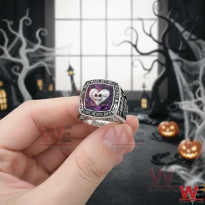 Hand holding a gothic ring with heart skull design in a moody dark fantasy background!