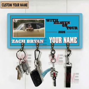 Ticket style wall key holder on a white background featuring with heaven on tour 2026 Zach Bryan and a custom name area with four metal hooks holding keys a car fob a tassel keychain a house key and a lanyard!
