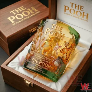 The Pooh one hundred year anniversary whiskey glass placed inside a wooden gift box with detailed character artwork and nostalgic presentation!