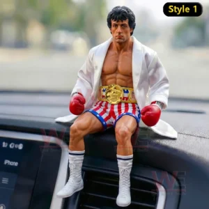 Rocky Balboa figure on a car dashboard wearing a white robe red gloves and a gold championship belt!