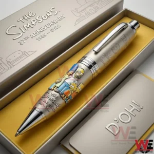 The Simpsons anniversary pen in an open box with yellow lining showing the Simpson family artwork and packaging text thirty seventh anniversary 1989 2026 with a Doh card.