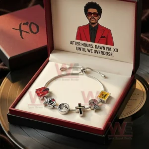The Weeknd After hours, Dawn FM XO Until We Overdose Adjustable Charm Bracelet 5 Open red and black gift box holding a silver adjustable charm bracelet with XO themed charms and lid artwork with album inspired text.