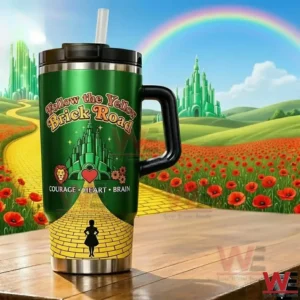 Green Follow the Yellow Brick Road tumbler with Emerald City artwork and courage heart brain icons on a wooden table with a rainbow and poppy fields behind it!