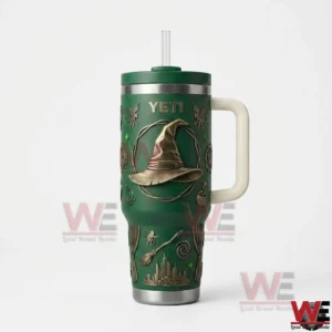 The Wizard of Oz Witch Hat Yeti Tumbler 5 Green Yeti tumbler with handle straw lid and embossed witch hat emblem displayed on a white background!