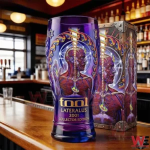 A purple collector beer glass with Tool Lateralus inspired artwork displayed on a bar counter next to its box!
