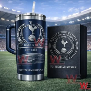 Navy Tottenham Hotspur insulated tumbler with handle and straw next to a collector style box on a football field with stadium stands behind!