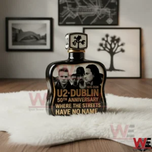A commemorative dark fragrance bottle with gold details celebrating a Dublin rock band anniversary displayed in a stylish room!
