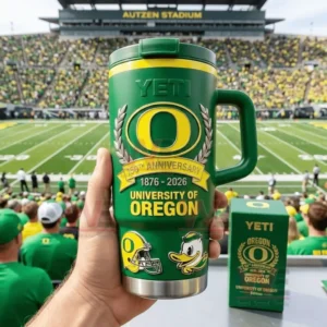 A green University of Oregon 150th anniversary insulated tumbler with handle and lid held at Autzen Stadium featuring the Oregon O logo 1876 2026 text and small helmet and duck mascot graphics!