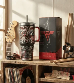 Black insulated tumbler with handle and straw decorated with classic rock music symbols on a wooden shelf!
