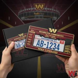 Washington Commanders 94th Anniversary Car License Plate Frame 3 Hands holding a Washington Commanders burgundy and gold license plate frame with championship years and Take Command text in front of a stadium themed background.