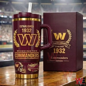 Burgundy and gold sports themed tumbler with handle straw lid and decorative box placed on a table with a blurred arena background!