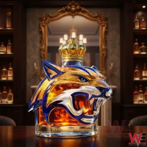 Wildcat head shaped championship bottle with crown cap on a wooden table in an upscale bar with liquor shelves and ornate mirror background!
