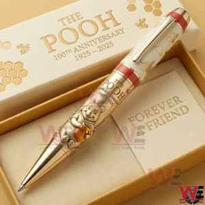 Cream and gold Pooh anniversary pen in a gift box with honeycomb patterns and one hundredth anniversary lettering!