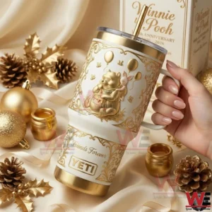 Hand holding a gold accented tumbler with cute bear artwork surrounded by warm decorative elements!