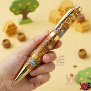 Winnie the Pooh 100th Anniversary Hundred Acre Wood Pen 3 Hand holding a Winnie the Pooh inspired commemorative pen in a soft playful setting!