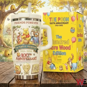 White commemorative metal tumbler with friendly character artwork standing next to a yellow presentation box on a wooden surface with a whimsical forest background!