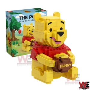 Yellow brick bear figure with a red shirt holding a honey pot displayed beside a themed product box!