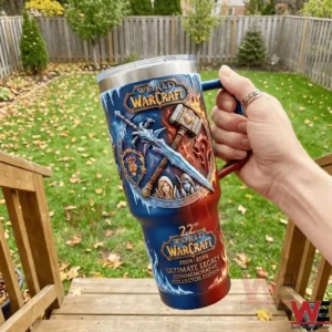 Hand holding a World of Warcraft ultimate legacy commemorative tumbler outdoors with detailed fantasy artwork!