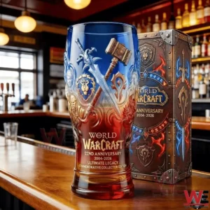 A World of Warcraft twenty second anniversary collectible glass with blue and red gradient design standing on a bar counter next to a themed collector box!