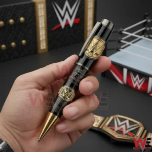 Hand holding a black and gold WWE anniversary commemorative pen with championship styling!