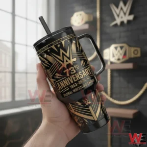 Hand holding a WWE anniversary themed insulated tumbler with gold details in a display room!