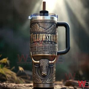 Yellowstone themed tumbler with embossed bison mountain scenery handle clear lid and straw displayed in a forest style setting!
