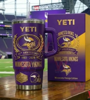 Purple Minnesota Vikings insulated tumbler with handle and commemorative box celebrating sixty five years displayed on a wooden table inside a stadium!