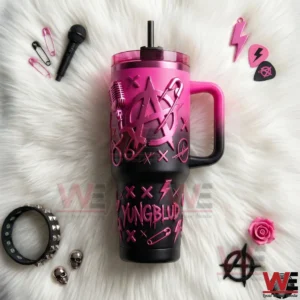 YungBlud Anarchy Circle A 40oz Tumbler 7 Yungblud inspired pink and black tumbler displayed on white fur with punk music accessories around it!