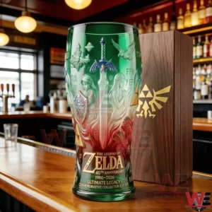 A collectible fantasy glass with green and red gradient design featuring The Legend of Zelda fortieth anniversary artwork standing on a bar counter next to a themed wooden box!