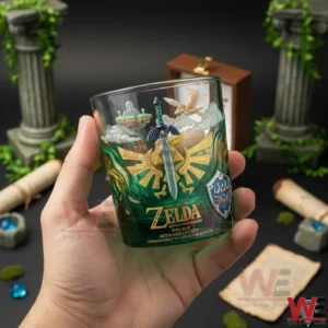 Zelda 40th Anniversary Skyward Legacy Whiskey Glass 7 Hand holding a Zelda anniversary whiskey glass with fantasy symbols in a dark studio setting!