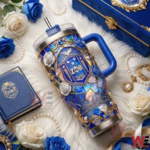 Blue luxury insulated tumbler with ornate crest and floral design on decorative surface!