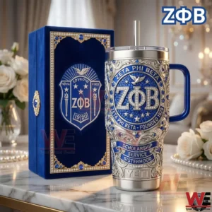 Hand holding a blue and silver metal tumbler with ornate design in a refined celebratory environment!