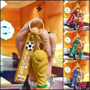Hand holding a world cup keychain with golden trophy charm!