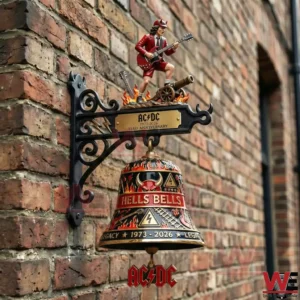 Wall mounted decorative bell with acdc themed hells bells design and a small guitarist figure on a brick wall!